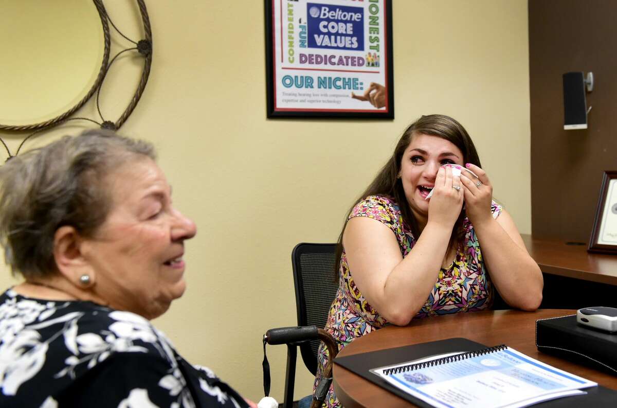 (Peter Hvizdak - New Haven Register)Loretta D'Aniello, 91, of West Haven, left, after being fitted for a Beltone BTE hearing aid , and D'Aniello's granddaughter Melissa D'Aniello, right, cry together during an emotional moment after Loretta realizes she can her clearly after receiving her hearing aids at the Beltone Hearing Center in Orange Tuesday, July 26, 2016.