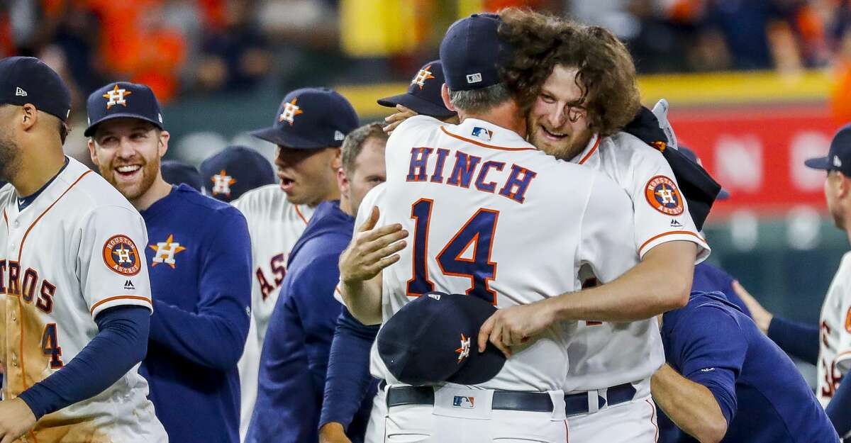 Houston Astros starting pitcher Gerrit Cole (45) hugs manager AJ Hinch (14) after the team wins Game 5 of the American League Division Series at Minute Maid Park in Houston, on Thursday, Oct. 10, 2019.
