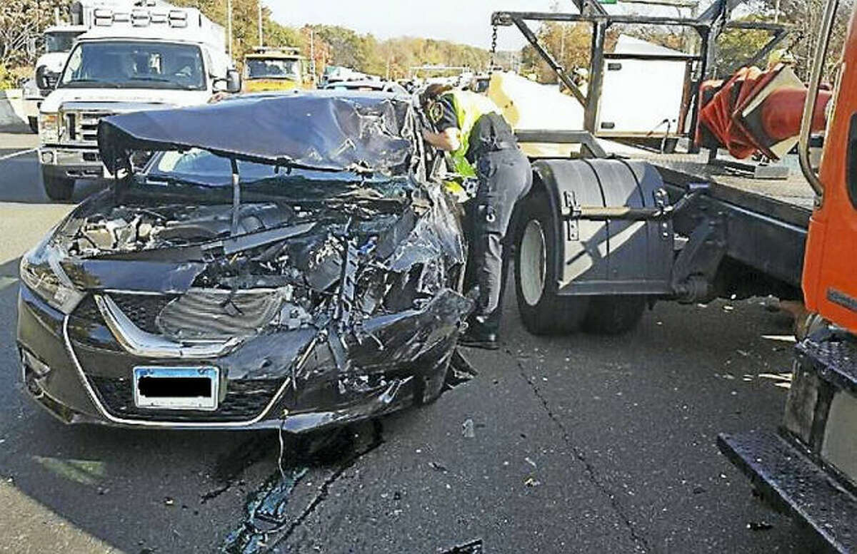 Two people were taken to the hospital Wednesday after their car crashed into the back of a state construction vehicle on Interstate 95 in Milford. Police are reminding people they must slow down and move over if they see the trucks stopped on the highway.