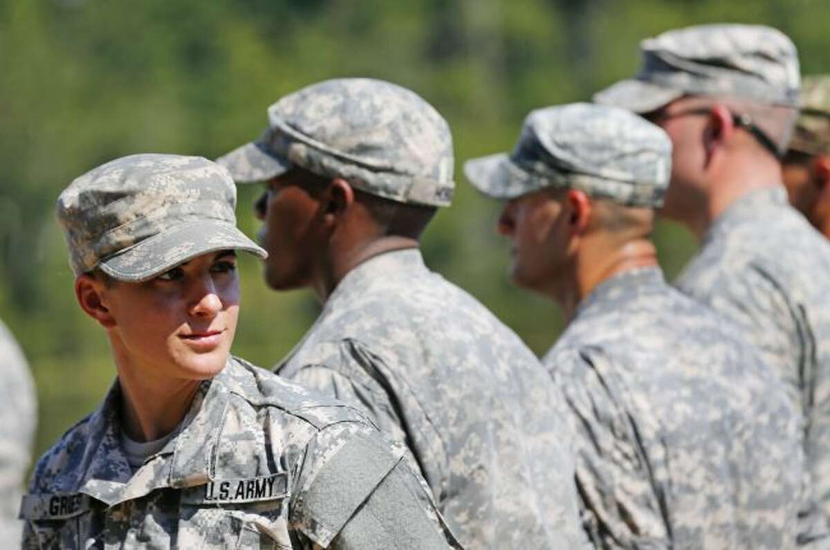 U.S. Army Capt. Kristen Griest, of Orange, Connecticut, left, smiles as she stands in formation during an Army Ranger School graduation ceremony, Friday, Aug. 21, 2015, at Fort Benning, Ga. Griest and First Lt. Shaye Haver became the first female soldiers to complete the Army’s rigorous school, putting a spotlight on the debate over women in combat. (AP Photo/John Bazemore)