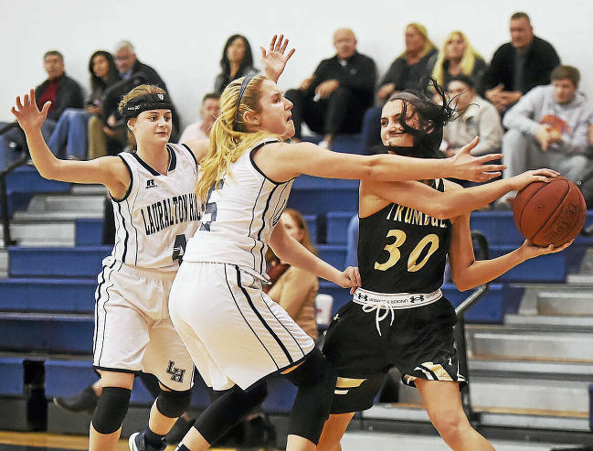 Lauralton Hall sophomore Julia Sendzik (5) and senior Colleen McCarthy (4) pressure Trumbull senior captain Victoria Ray in a win for the Eagles defeating the Crusaders 59-50 Wednesday at Lauralton Hall in Milford.
