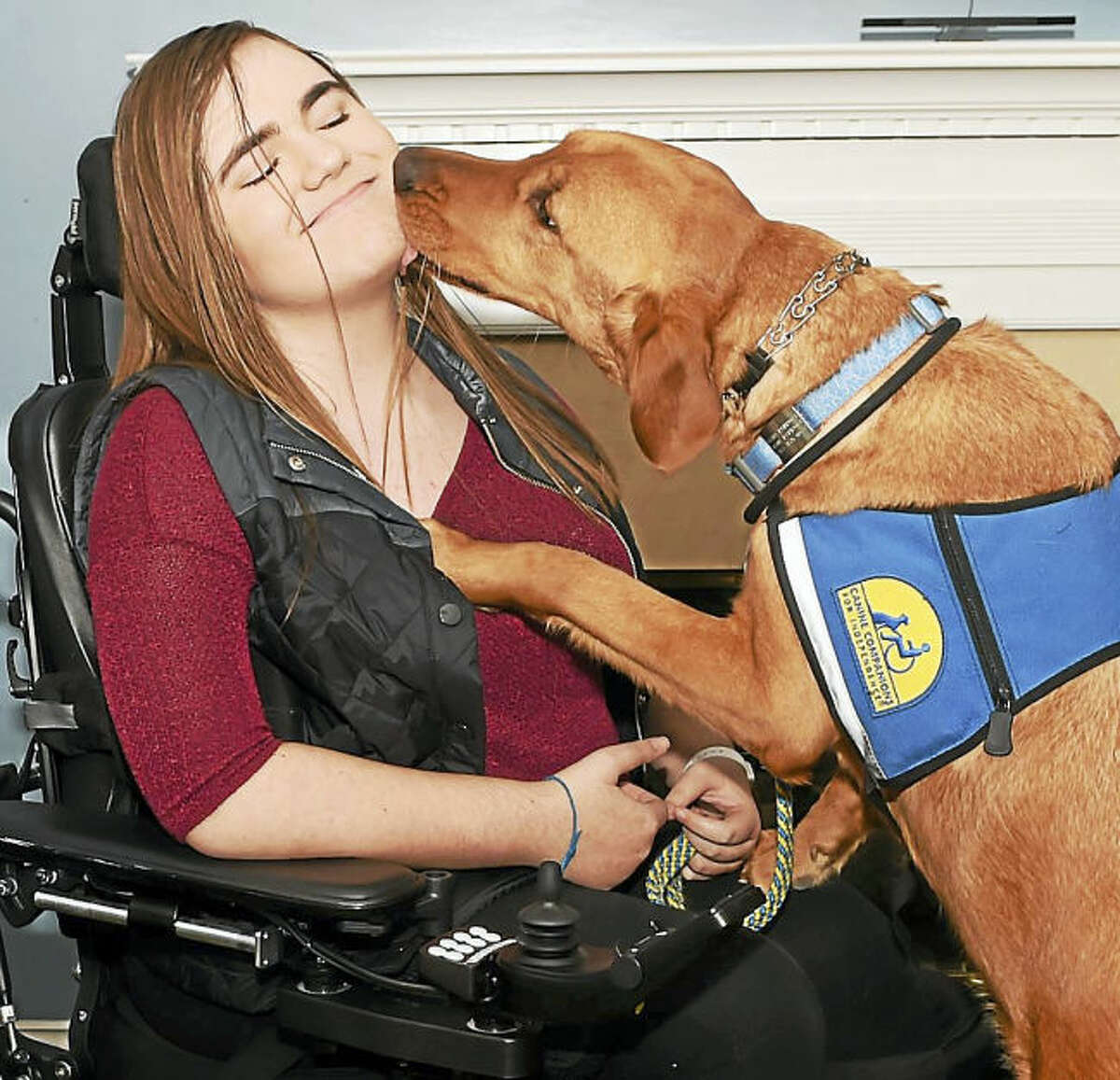 Dana Parrott, 14, of Milford, with Zinc, who was provided by Canine Companions for Independence.