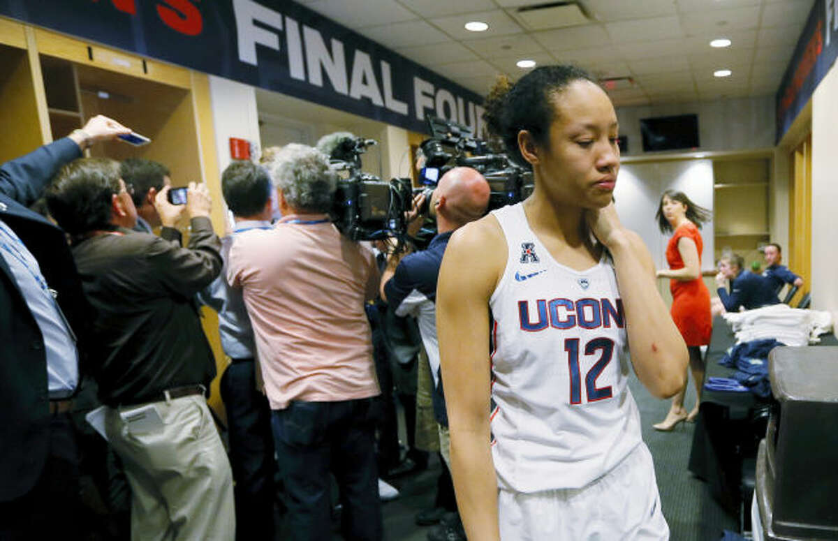 UConn’s Saniya Chong (12) walks through the locker room after the Huskies’ loss to Mississippi State on Friday.