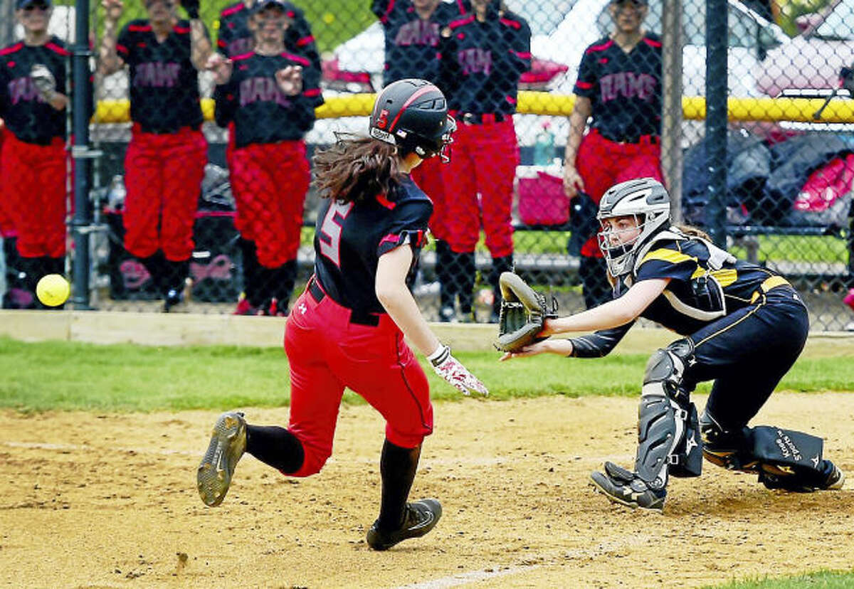 Amity catcher Rachel Crow, right, waits for the ball and blocks home plate before tagging out Cheshire’s Lindsay Abramson during the second inning Monday in Woodbridge.