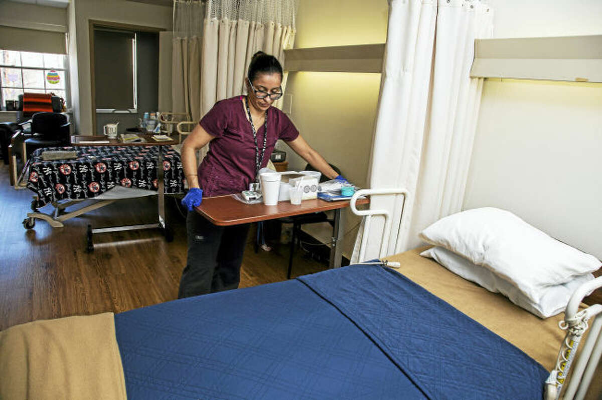60 West nurse Irene Rivera, LPN, cleans a patient’s room at the Rocky Hill nursing home.