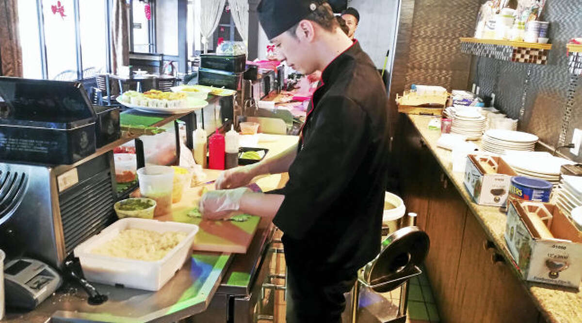 A sushi chef prepares for the lunch crowd at Koi Sushi, 185 Main St. in East Haven.