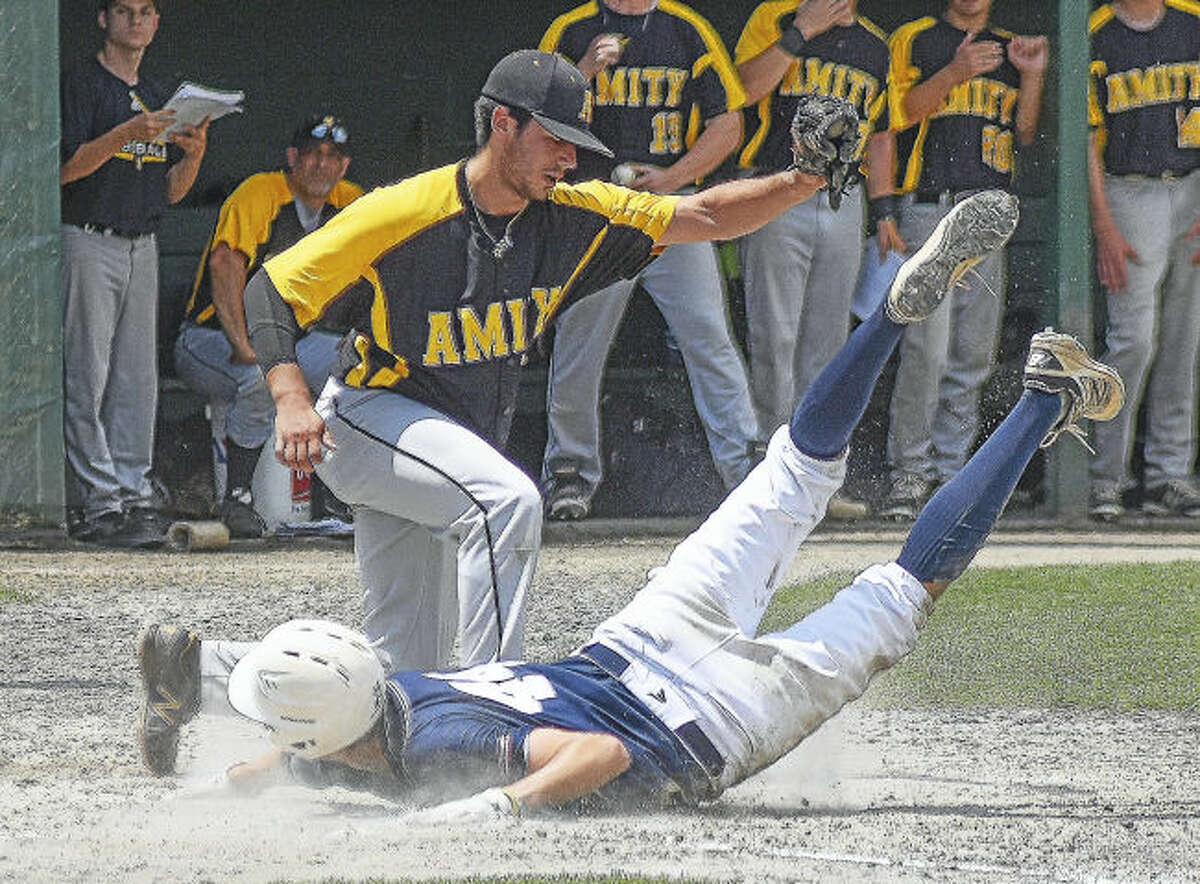 Amity pitcher Max Scheps, top, tags out Staples’ Michael Fanning at the plate after a wild pitch during Saturday’s Class LL championship game at Palmer Field in Middletown.