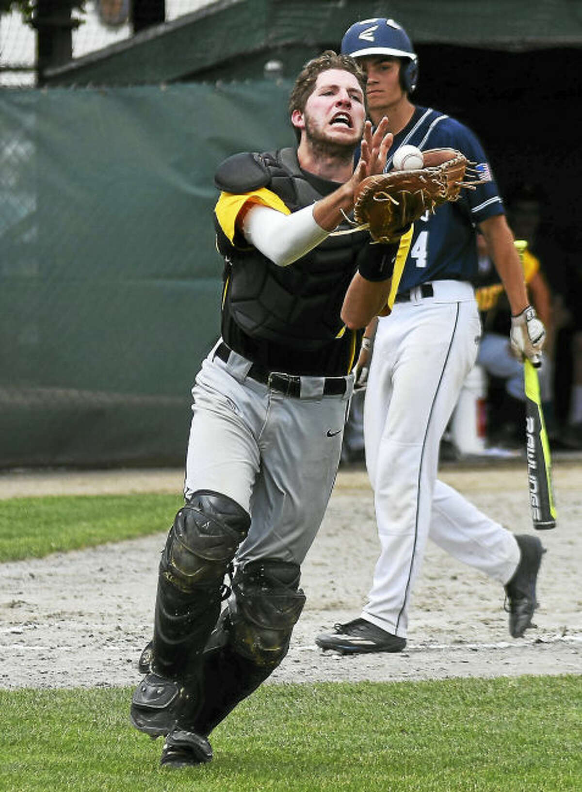 Amity catcher Pat Winkel extends to catch a pop up bunt by Staples’ Max Popken during Saturday’s Class LL championship game in Middletown.
