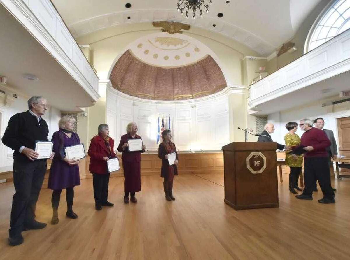 David Duffner, chairman of the Immigration Committee of Milford Speaks Out, fourth from right, with state Rep. Pamela Staneski and Milford Mayor Ben Blake, far right, congratulates Joseph Garbus as one of several immigrants honored for service to the community. Also honored were, from left, Terrance Copeland, Eeva Copeland, Nadia Bajrakterevic and Wendy Safyre.