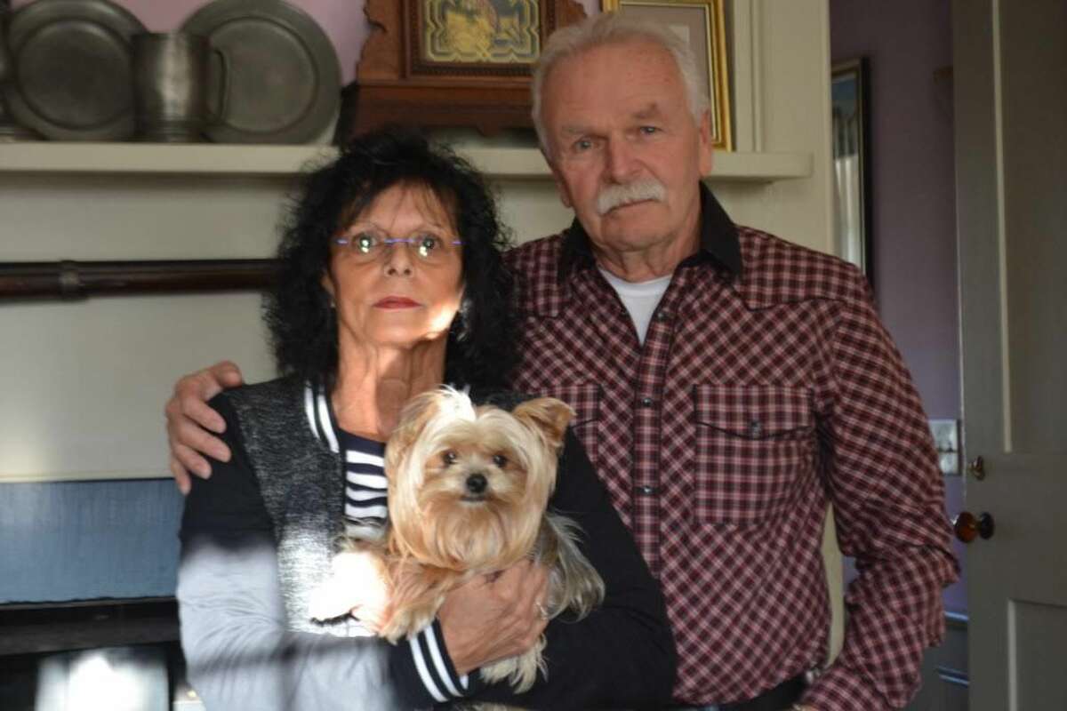 Ann and William Barrows hold their 8-year-old Yorkie Lola at their Main Street home in Portland.