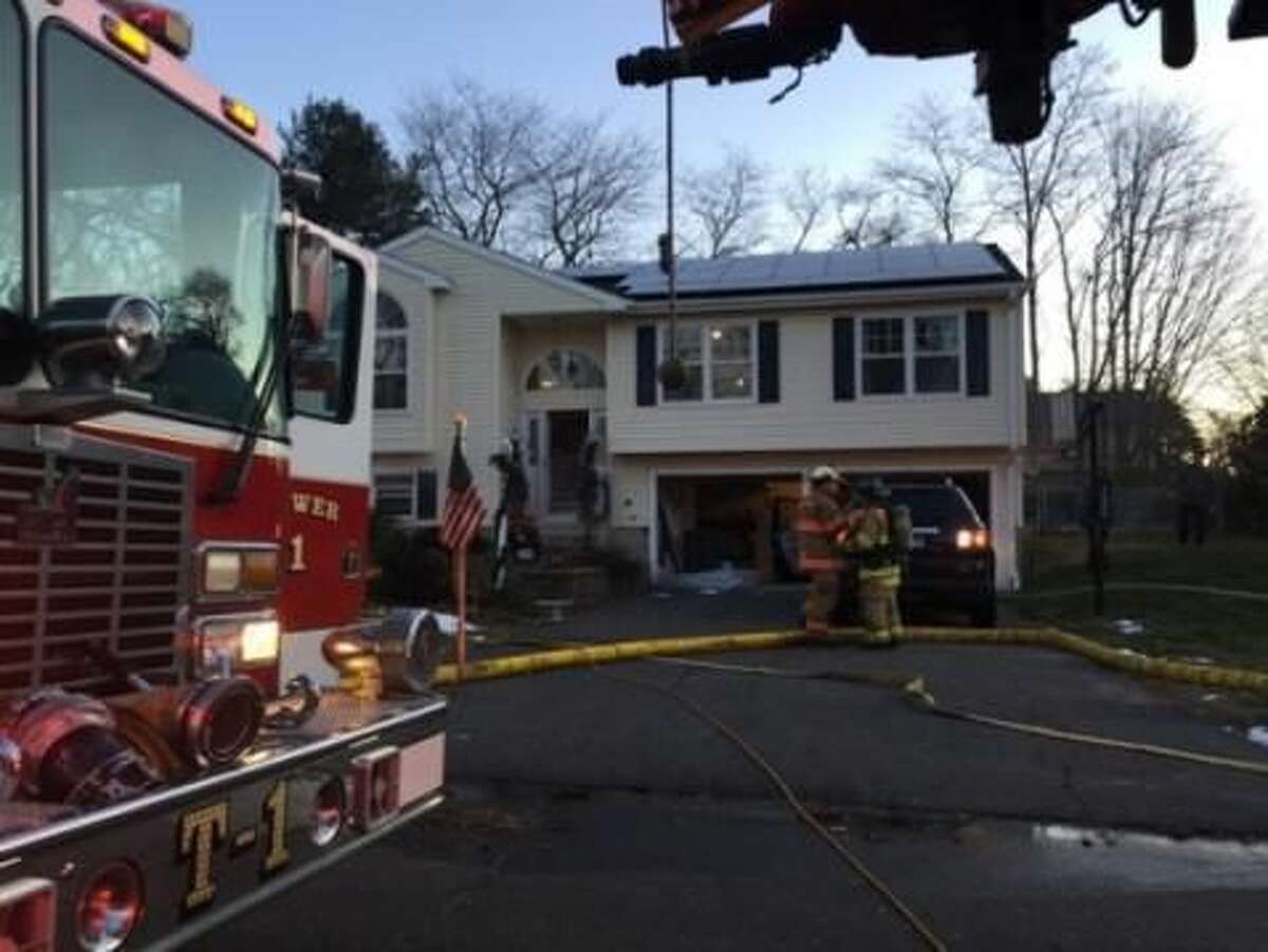 Firefighters inspect a home where a dryer fire broke out Wednesday.