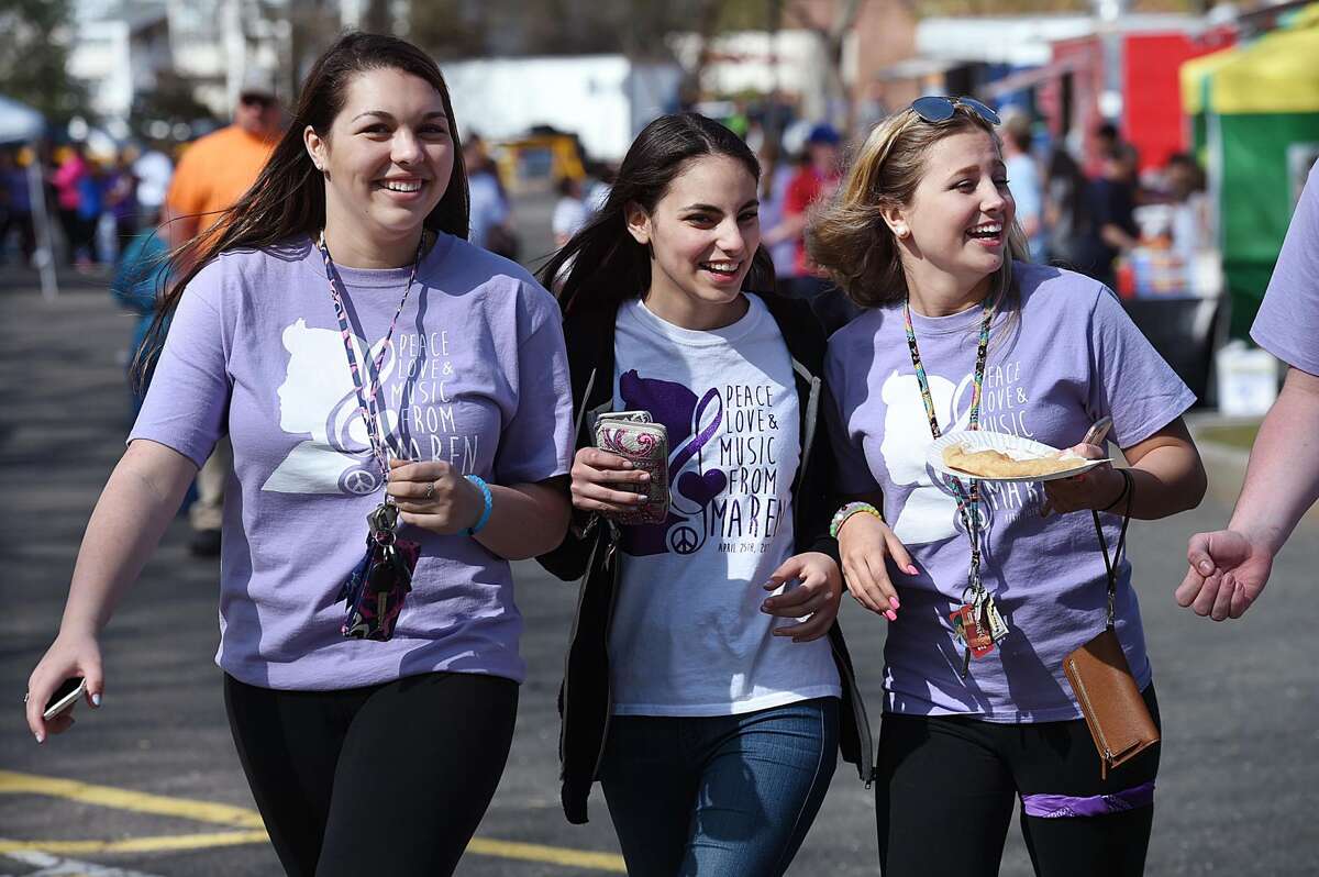 Jonathan Law juniors Lexi Fisk, 17, Basima Karzoun, 16, and Marissa Tollack, 16, walk through food truck area at the second annual Peace, Love, & Music from Maren at Jonathan Law High School, Saturday, April 30, 2016, in Milford. The event is a way to remember and celebrate the life of Maren Sanchez who was killed in the school's hallway hours before the prom April 25, 2014.