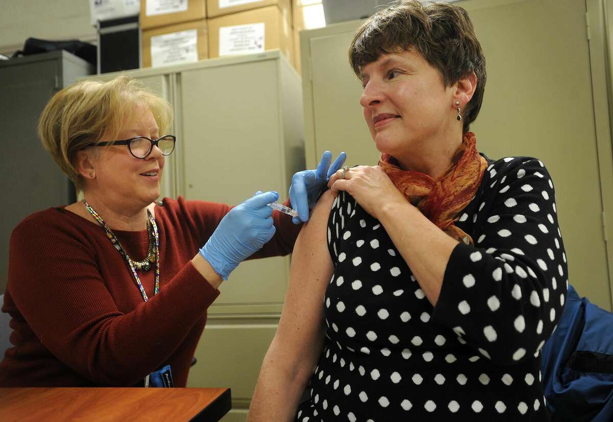 Public Health Nurse Kathy Malski, RN, gives a flu shot to Peggy Jo Thomas, of Morris, during a free flu shot clinic at Milford Health Department offices in Milford.