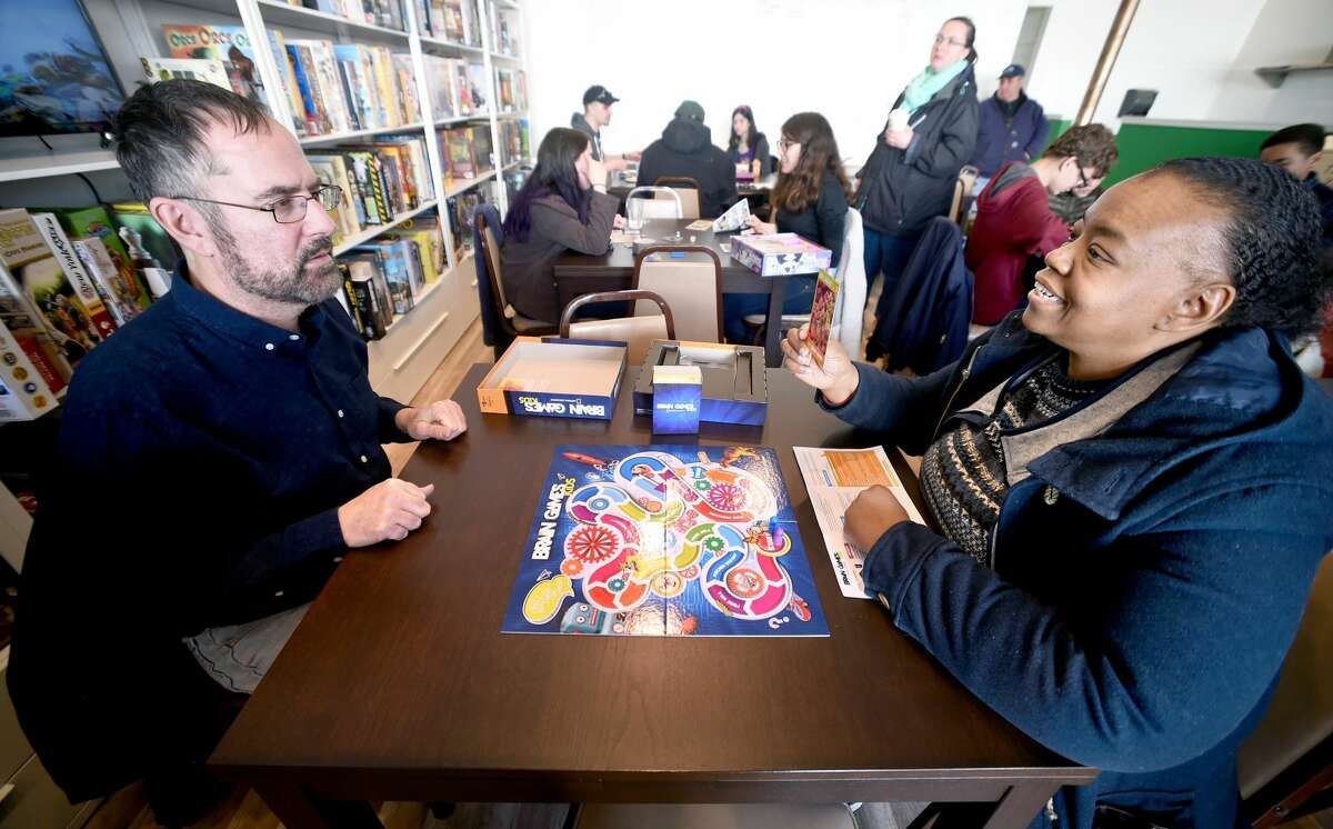 Keith Iodice (left) of Fairfield and Sandy Booth of Norwalk play Brain Games at Hawkwood Games in Milford.