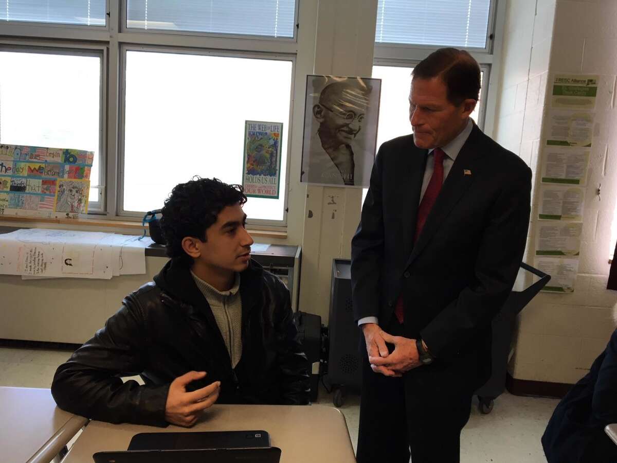 At left, Omar Moussa,17, a refugee from Syria talks with U. S. Sen. Richard Blumenthal at Cross High School.