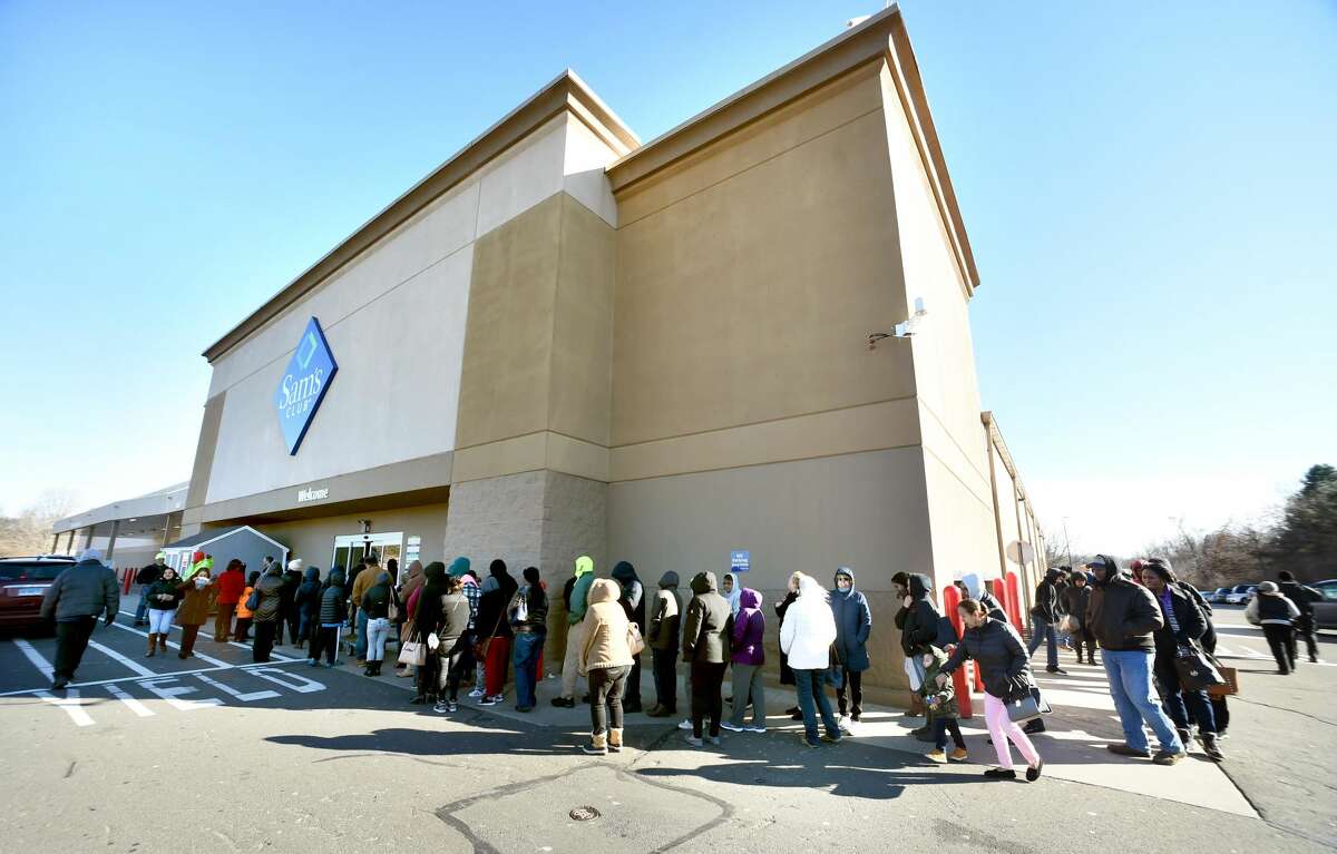 Shoppers stand in line outside of the entrance to Sam's Club in Orange on Jan. 14. The store is slated to close at the end of the month.