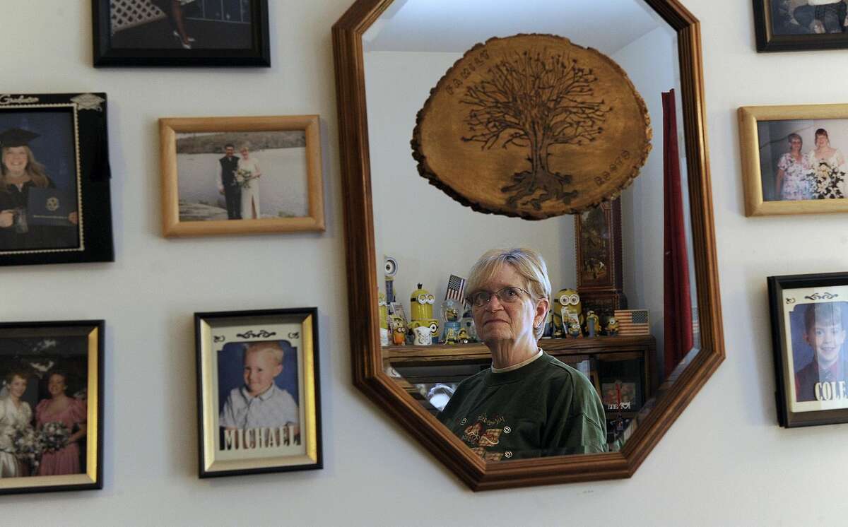 Kathy Sivertsen, 69, is the president of the resident association at Butter Brook Hill Apartments in New Milford, where many are concerned about the state budget. A hobby is geneology and she surrounds herself with family photos in her living room.