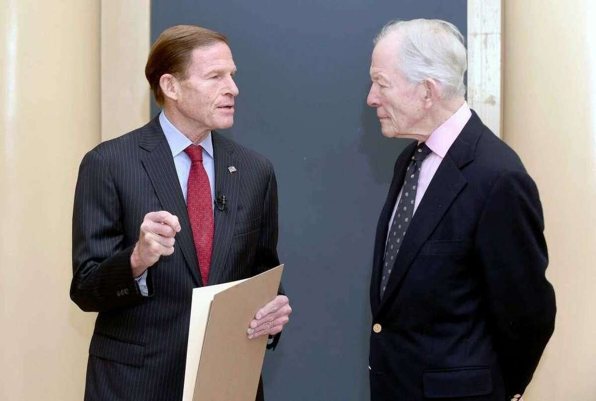 U.S. Senator Richard Blumenthal holds a resolution concerning a search for the San Antonio Rose B-17 Flying Fortress Heavy Bomber that went down during World War II in the Pacific Ocean and remains missing at Woolsey Hall in New Haven on November 10, 2017. At right is Doug Walker, son of Brigadier General Kenneth N. Walker, whose father was part of the crew of 11 aboard the plane when it went down under enemy fire.