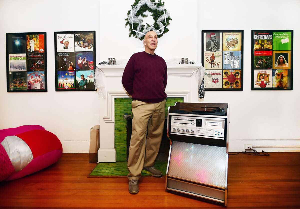 Sam Goldenberg plays an album on his 1970's Morse Electrophonic Jukebox surrounded by his collection of Christmas music on exhibit on the second floor at the John Slade Ely House at 51 Trumbull St. in New Haven.