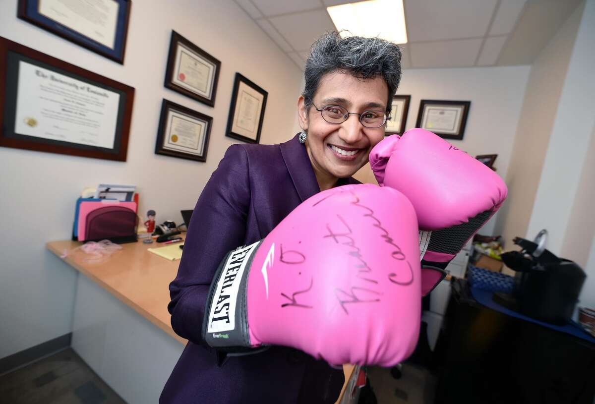 Dr. Anees Chagpar, Assistant Director of Global Oncology at the Yale Cancer Center, is photographed in her office in the Smilow Cancer Hospital with a pair of boxing gloves she received from the Soho Hair Salon when she began work in New Haven.