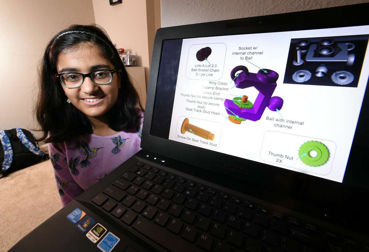 Aditi Bhattamishra, 12, is photographed with her entry in NASA's Future Engineers Two for the Crew Challenge, a restraint and mobility aid she designed for the International Space Station, at her home in Orange.