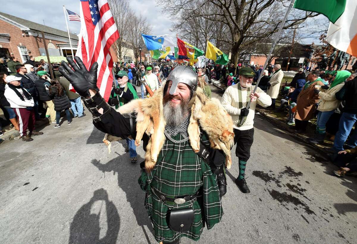 Dave Conroy with the Irish Heritage Society of Milford waves to the crowd during the annual St. Patrick's Parade on Broad St. in Milford on March 10.