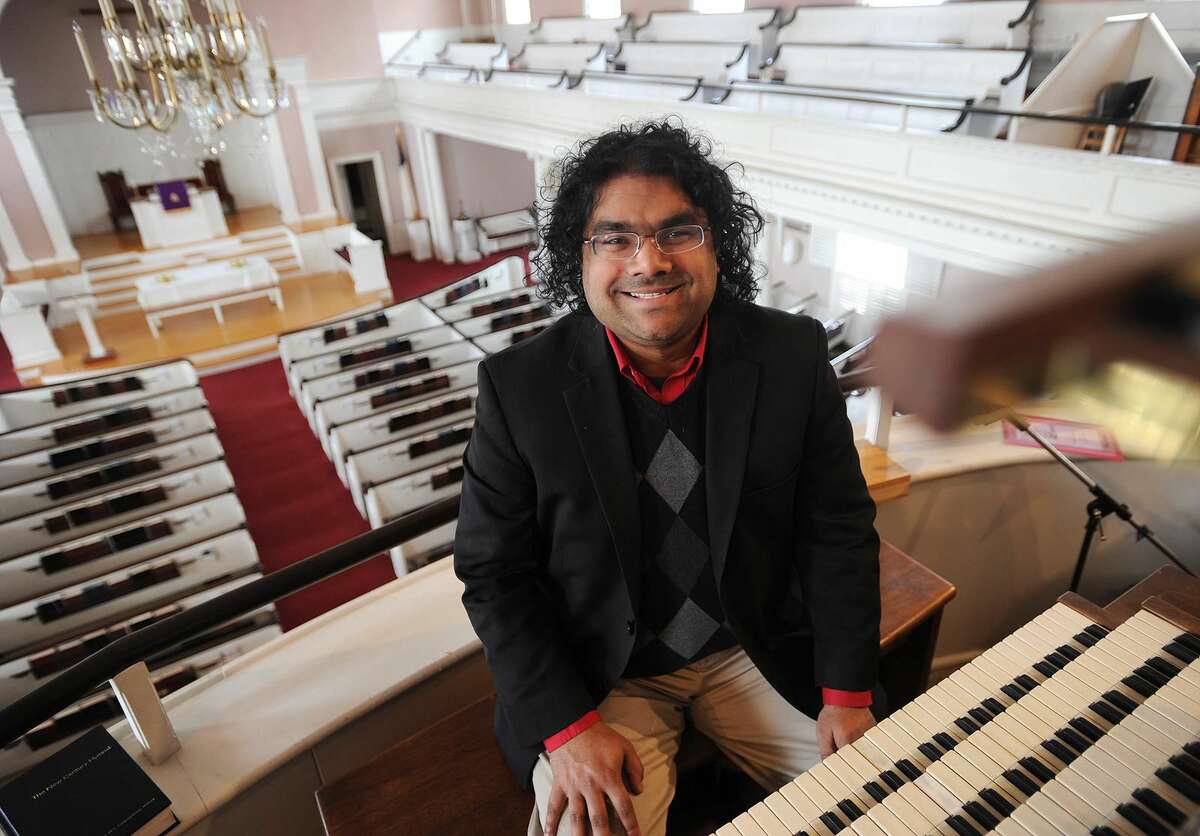 Minister of Music Daniel Brownell sits at the organ at the First United Church of Christ in Milford last Wednesday, March 14.