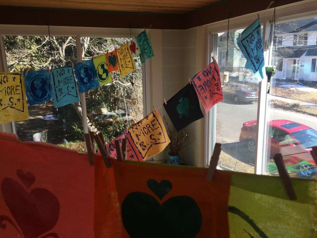 Three Westville women are hanging flags around New Haven promoting unity and peace. These are hanging inside Tina Santoni’s sunroom.