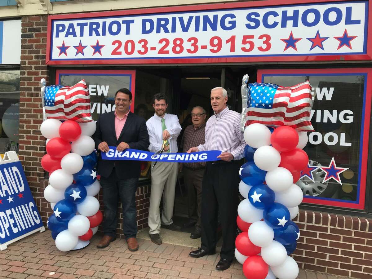 From left, Mayor Ben Blake, Owner Chris Boccarossa, Jack Bruno and Gary Mullin perform the ribbon cutting ceremony.