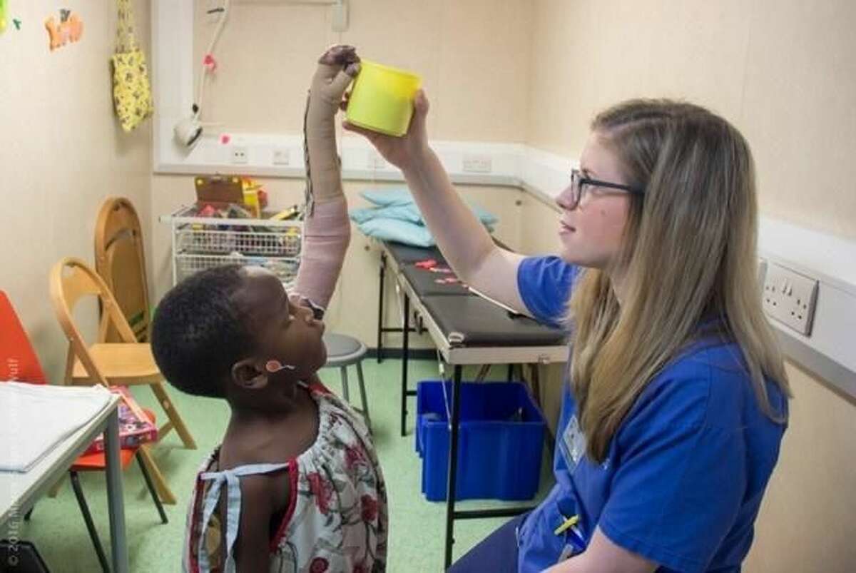 Elisabeth Mordecai, an occupational therapist with a specialty in hands, treats a burn victim aboard a hospital ship in Africa.