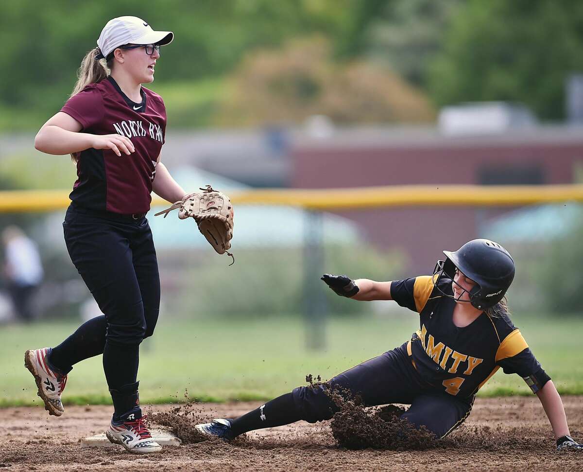North Haven shortstop Caitlin Ranciato looks for the throw as Amity’s Rachael Crow steals second base on Thursday.