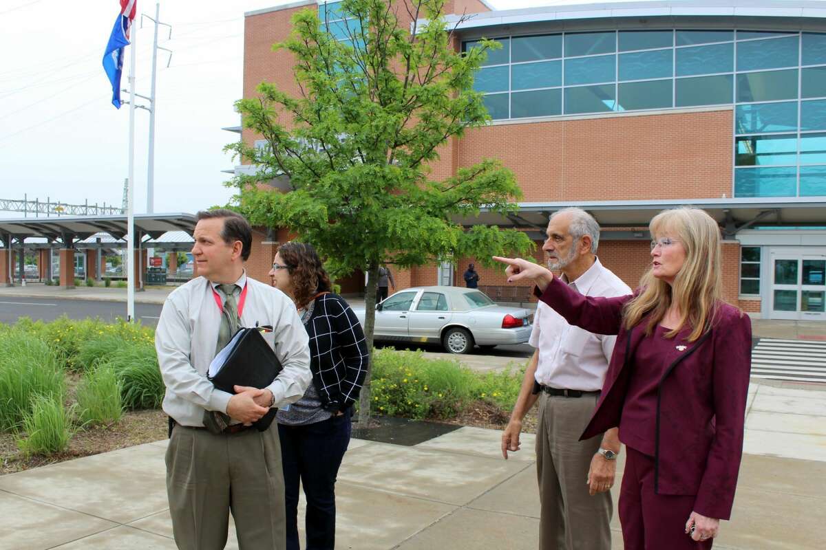 West Haven Mayor Nancy Rossi, with acting Public Works Commissioner Lou Esposito, right, discusses landscaping and property maintenance of the West Haven train station with state DOT Assistant Rail Administrator Richard T. Jankovich and DOT Transportation Rail Officer Marlene Cordero.