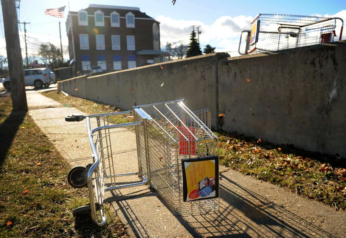 Shopping carts are blown from the parking lot outside Xpect Discounts at the intersection of High Street and the Post Road in Milford on Jan. 31, 2013.