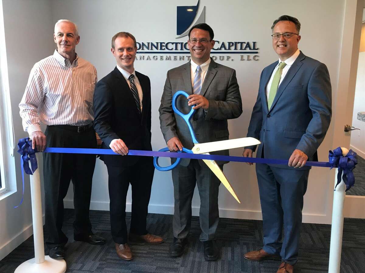 From left, Gary Mullin, Brian Parke, Mayor Ben Blake and Eric Tashlein cut the ribbon celebrating Connecticut Capital Management Group's 20th anniversary and new location.