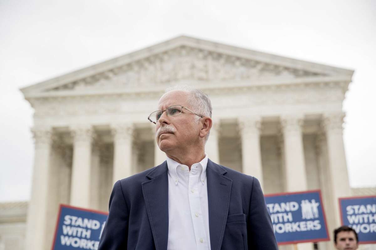 Plaintiff Mark Janus stands outside the Supreme Court after the court rules in a setback for organized labor that states can't force government workers to pay union fees, Wednesday, June 27, 2018, in Washington.