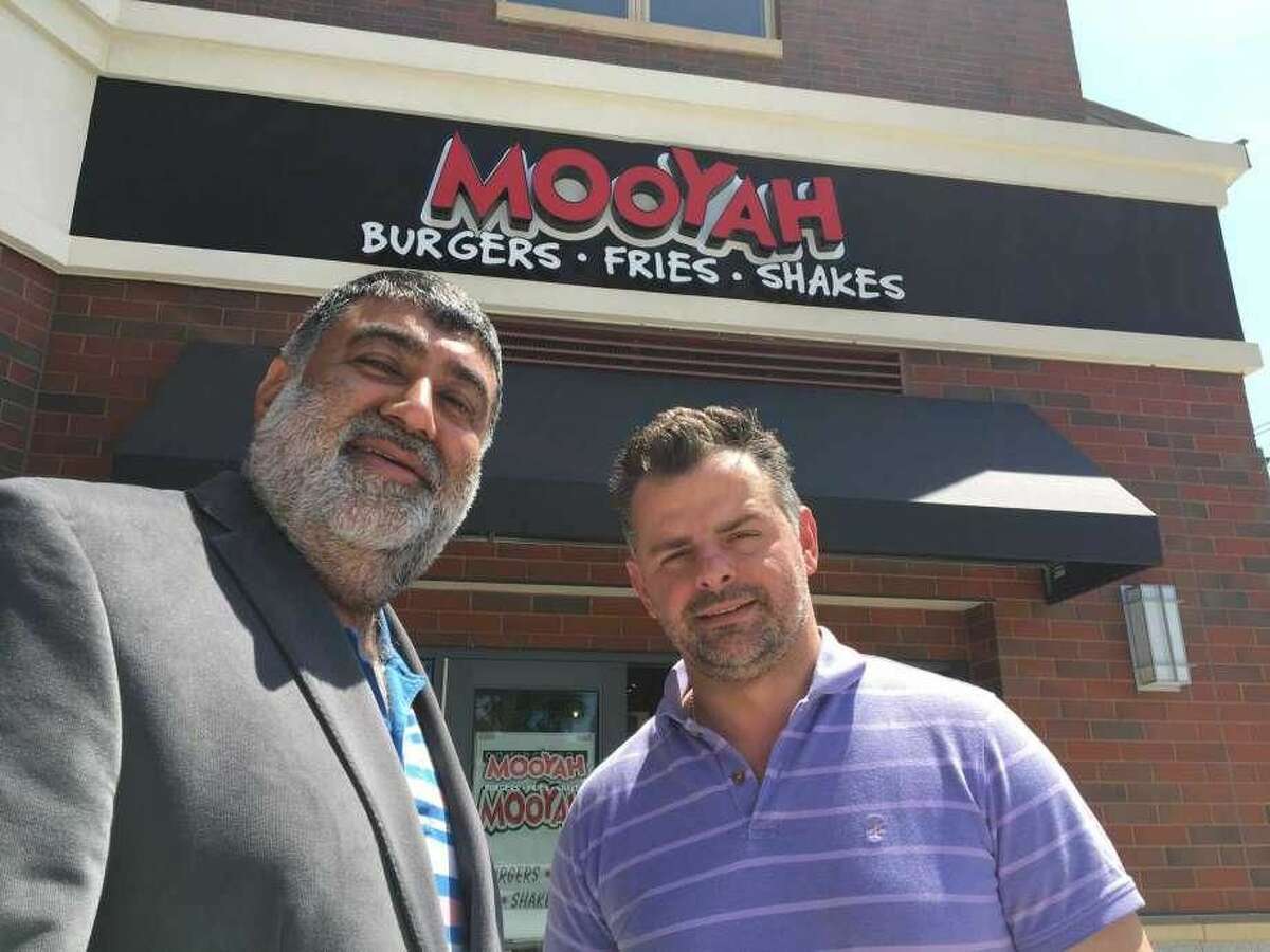 Mooyah Burgers franchise owner Prakash Wadwhani and General Manager Anton Tomaj outside the new West Haven restaurant.
