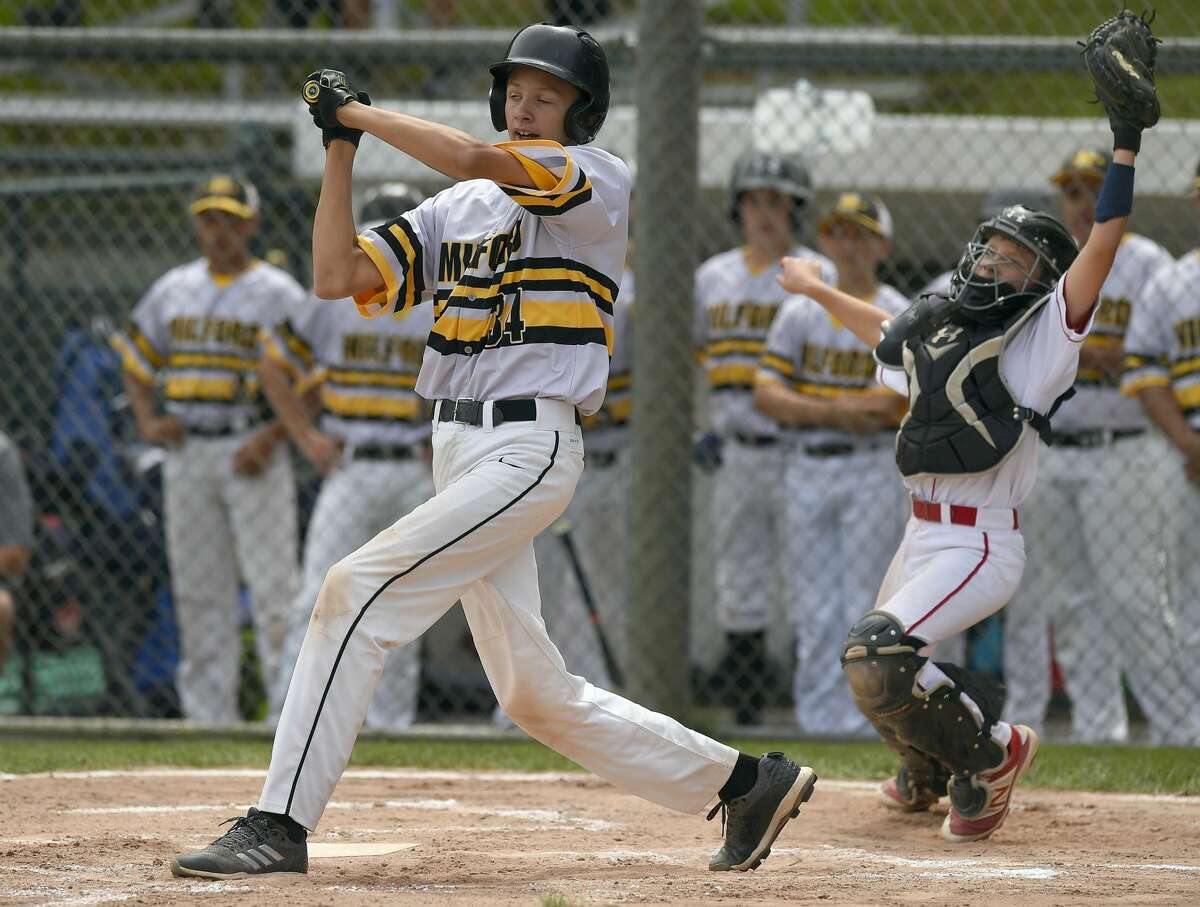 Milford's Nolan McKenna-Hansen takes a check swing as Fairfield American catcher Timmy Domizio reaches for the high pitch during the third inning in a Section 1 Little League Championship at Drotar Park on July 21, 2018 in Stamford, Connecticut. Fairfield American defeated Milford 5-2.