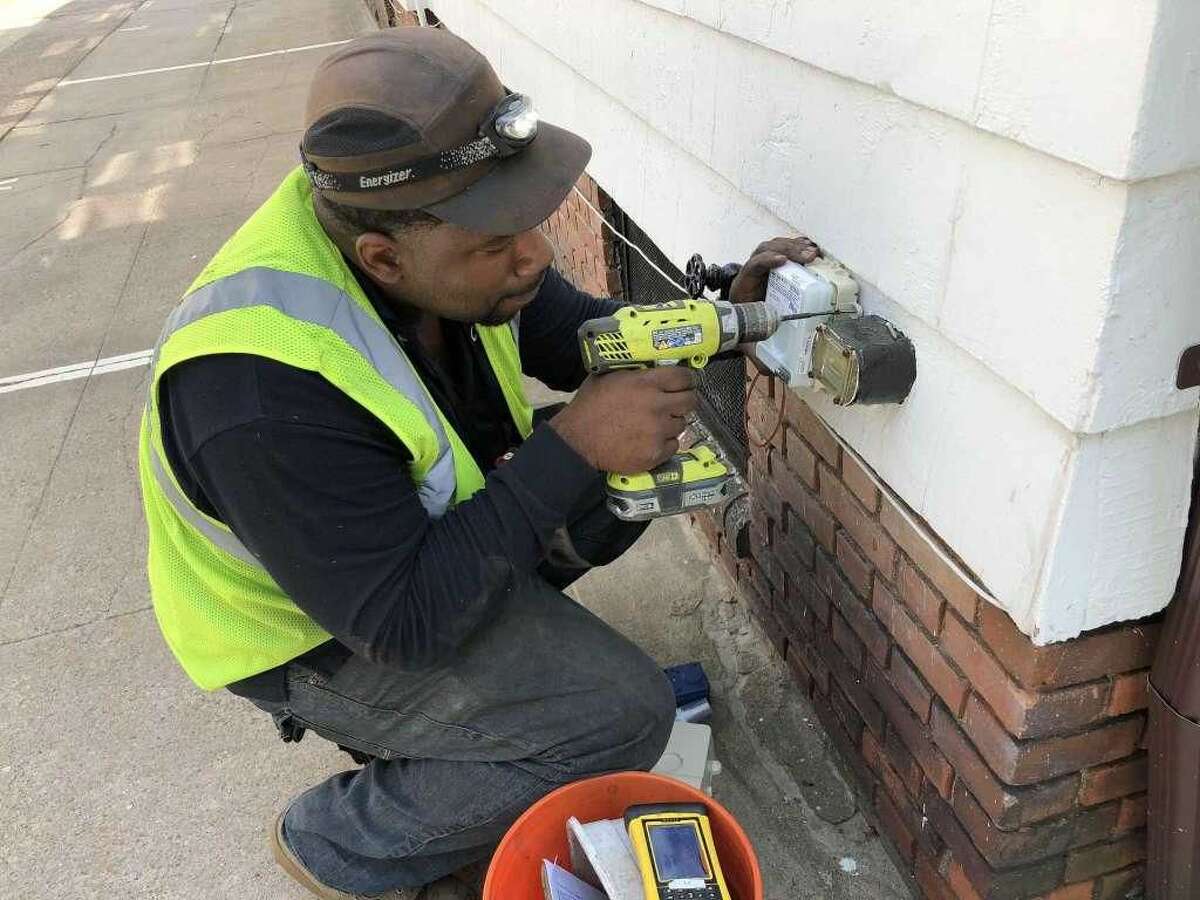 About 13,000 South Central Connecticut Regional Water Authority customers in West Haven are about to get the water industry's latest metering technology installed beginning next month. Here is an installer doing necessary work outside a customer's house.