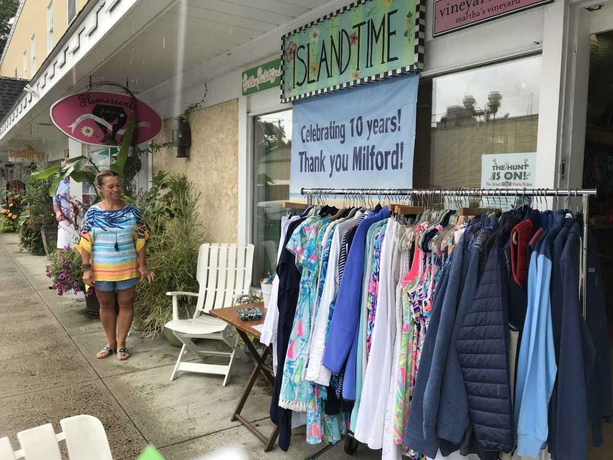 Susan Stanek, co-owner of Island Time, peruses bargains at the Milford Sidewalk Sale.