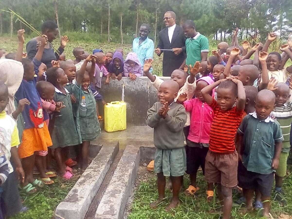 Children in Ugandan village are all smiles over the arrival of water.
