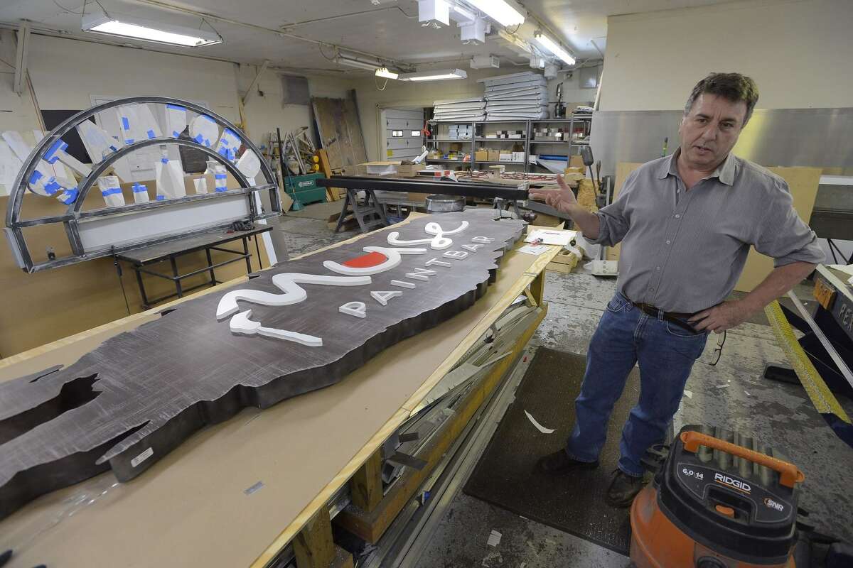 Ivo Granata talks about the many projects, such as an eight-foot long sign for Muse Paintbar, in the shop of his company, Granata Sign Company in Stamford on Nov. 1, 2016.