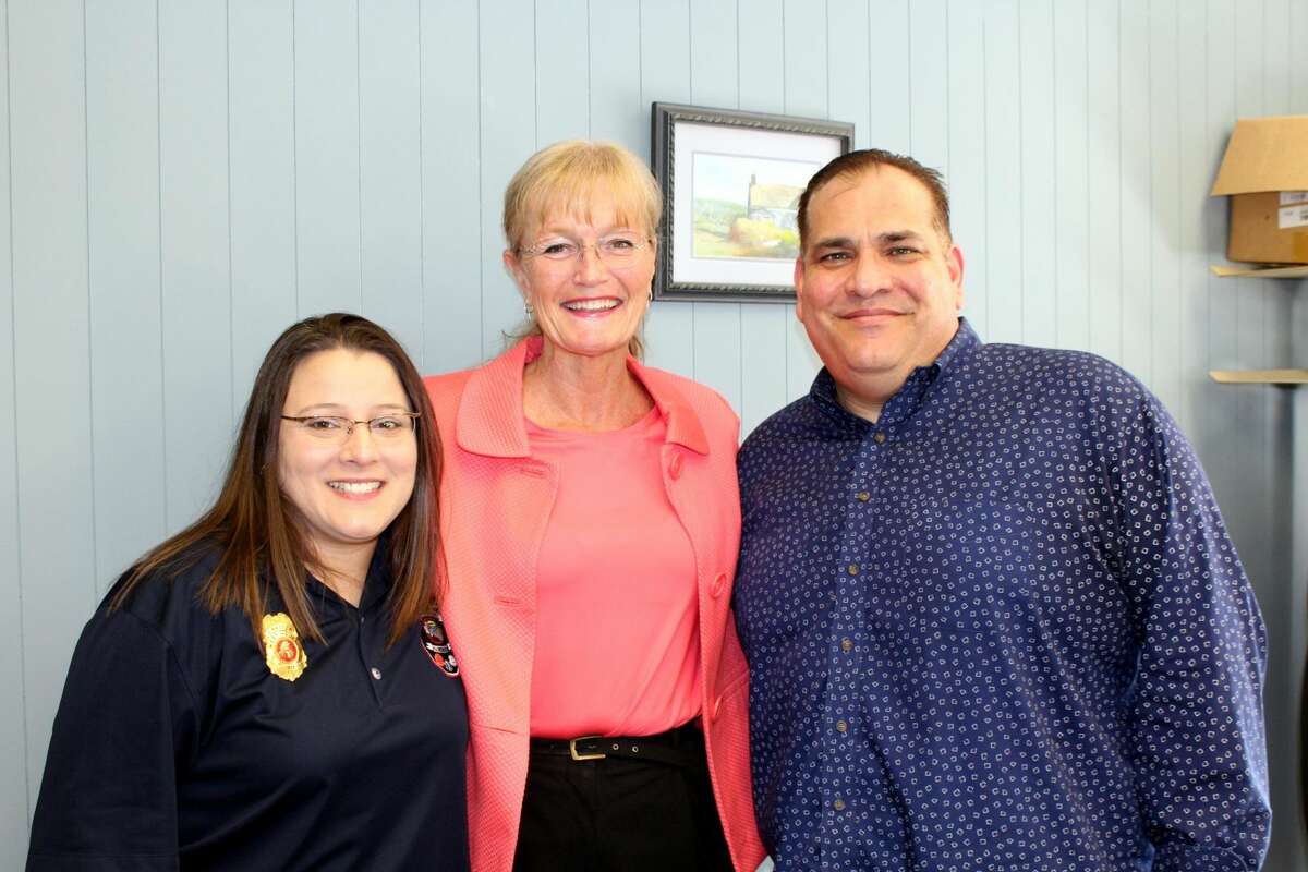 West Haven Mayor Nancy Rossi, center, congratulates 911 dispatcher Jennifer Amendola, left, on her promotion to director of the 911 Communications Center and outgoing Director Abe Colon, right, on his impending retirement.