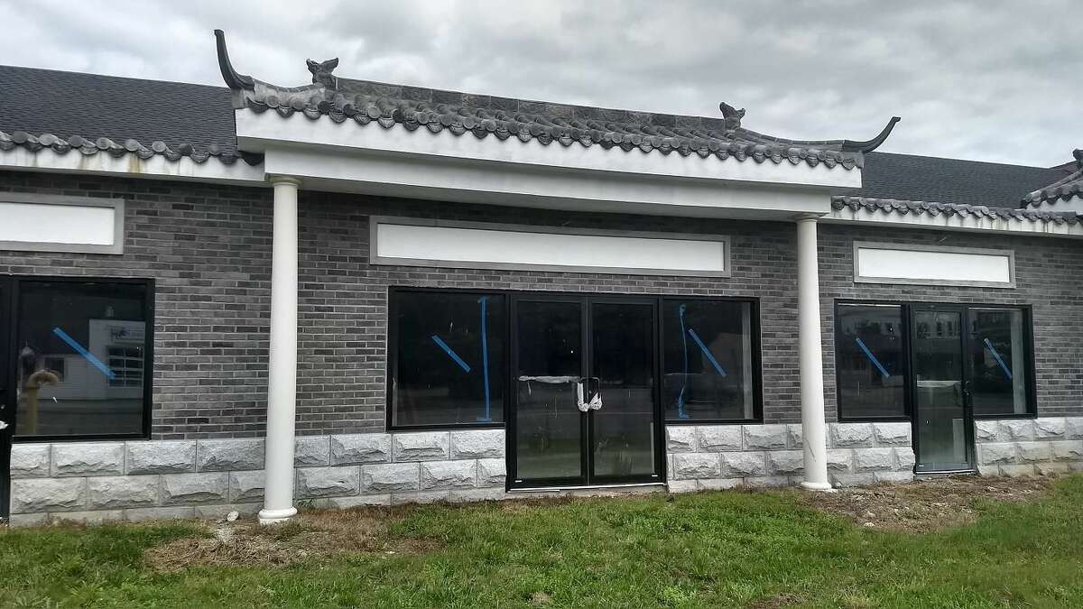 A close-up view of new Asian marketplace under construction, whose owners face hefty fines for letting the site fall into disrepair, in violation of the city's blight ordinance.