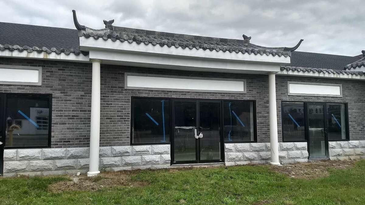 A close-up view of new Asian marketplace under construction, whose owners face hefty fines for letting the site fall into disrepair, in violation of the city's blight ordinance.