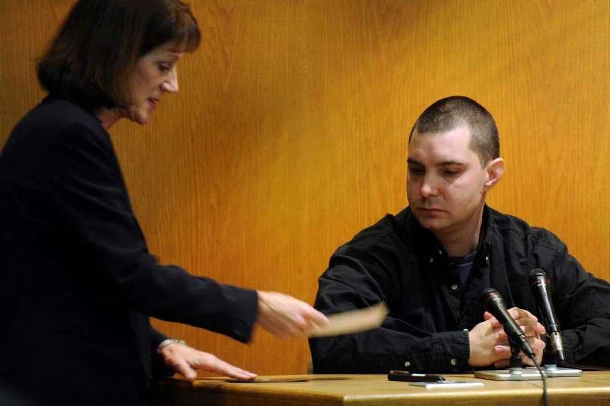 Assistant state's attorney Margaret Kelley (left) shows a witness photographs in evidence during a 2011 trial.
