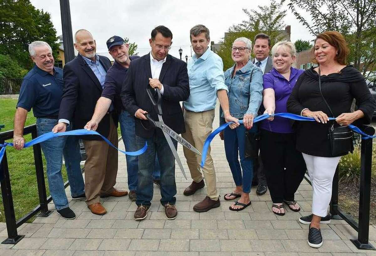Milford Mayor Ben Blake cuts the ribbon to commemorate the completion of Founders Walk, a landscaped path connecting downtown to Fowler Field. Milford led all southwestern Connecticut cities for economic performance in 2017, according to an October 2018 report by the Department of Labor, with New Haven tops statewide.