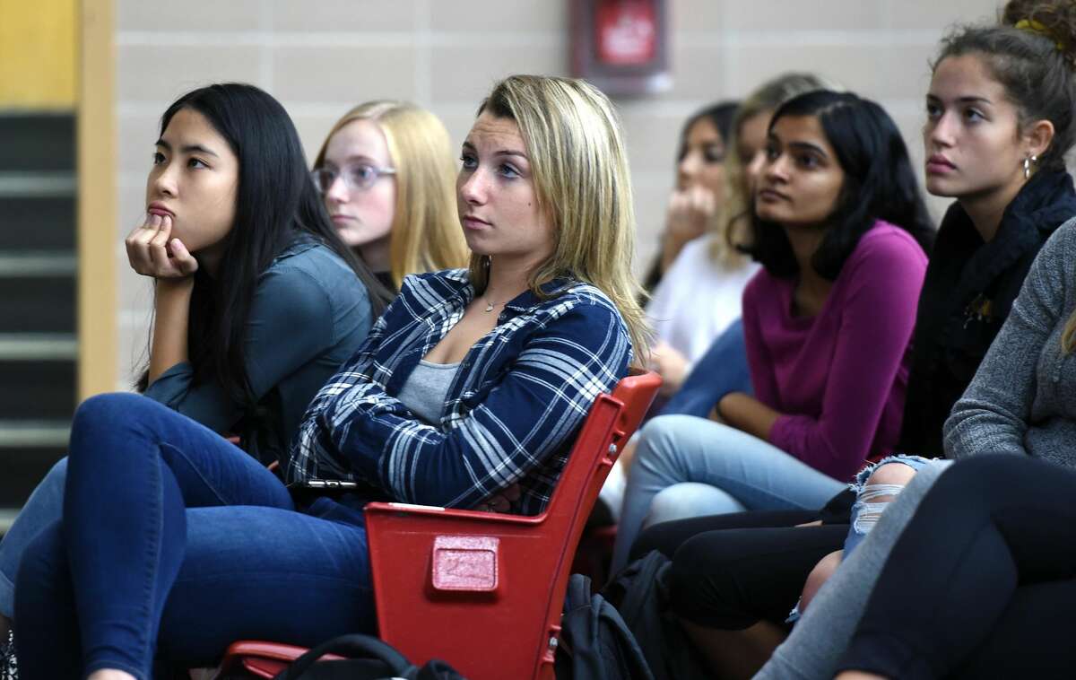 Students listen to Darcy Kerrigan of the Thirst Project speak at Jonathan Law High School in Milford at the invitation of the Key Club about the lack of clean drinking water in Swaziland and much of the world.