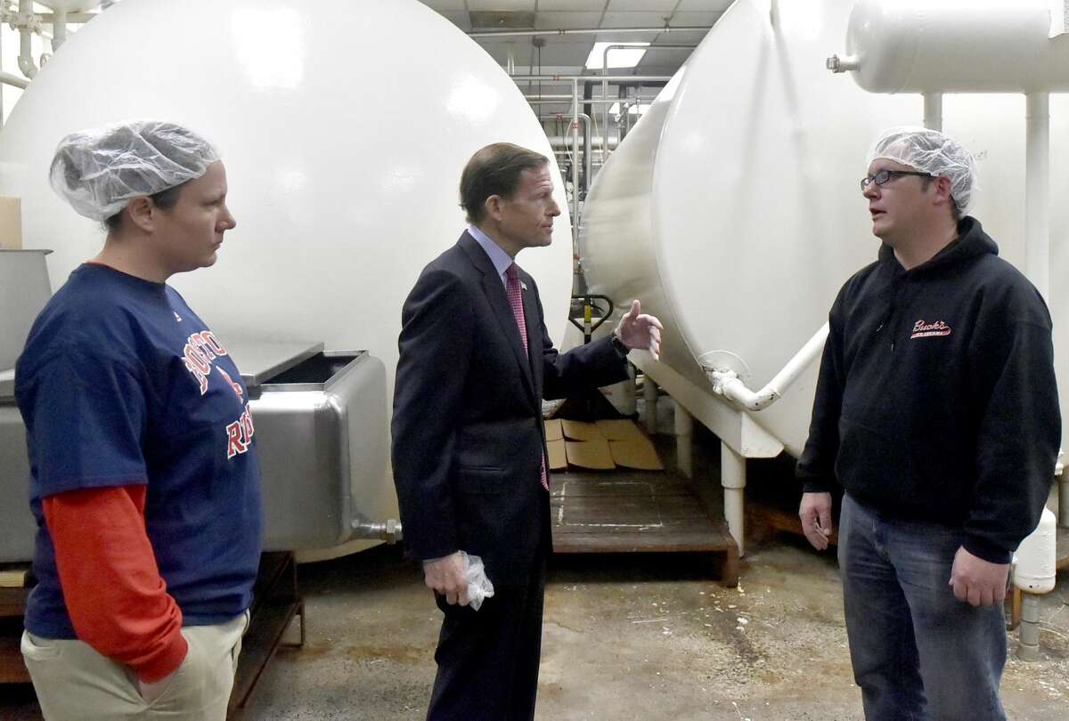Sara Buck, left, and her brother Chris Buck, right, both of Buck's Ice Cream manufacturing plant in Milford, give U.S. Senator Richard Blumenthal (D-Conn.), center, a tour of the plant on Pepe's Farm Road. Buck's Ice Cream was awarded the Small Business Adminstration 2018 Family Owned Connecticut Business of the Year.