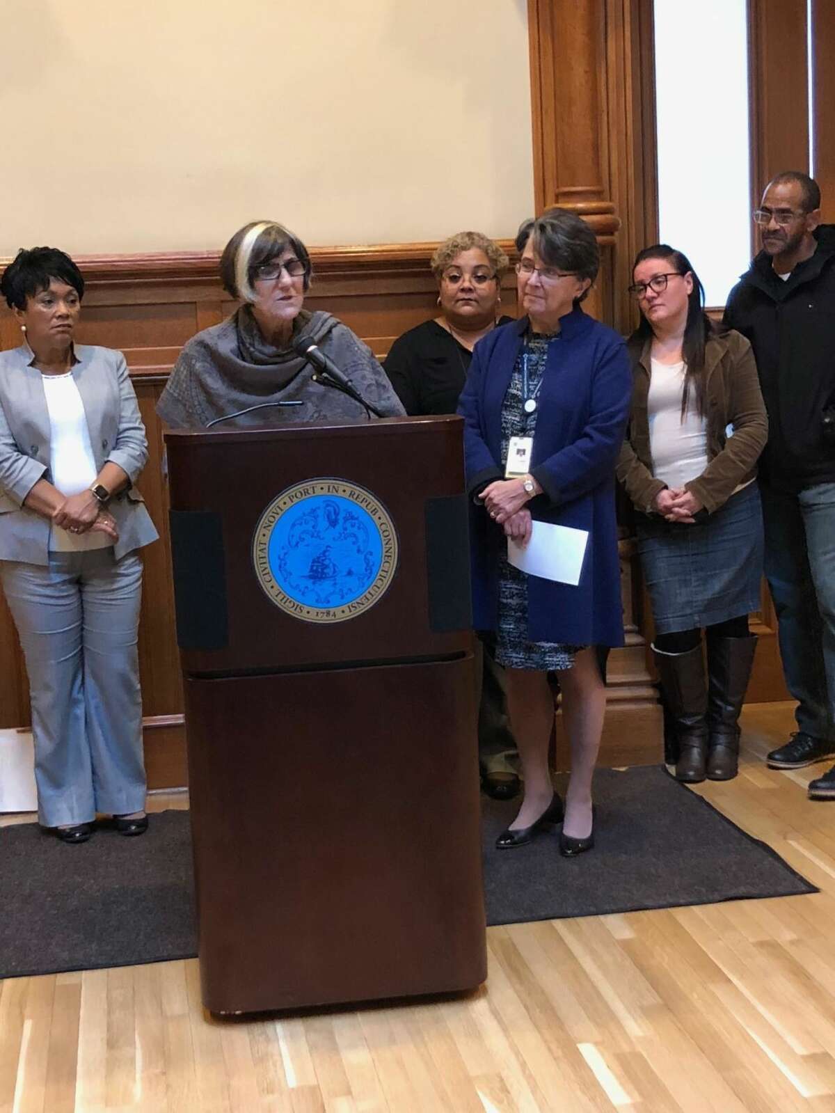 U.S. Rep. Rosa DeLauro, D-3, at podium, reminds residents to sign up for the Affordable Care Act. Far right is Pedro Garcia, who was able to get retroactive coverage when he discovered he had a heart issue. He is next to his wife, Marisol Velez.
