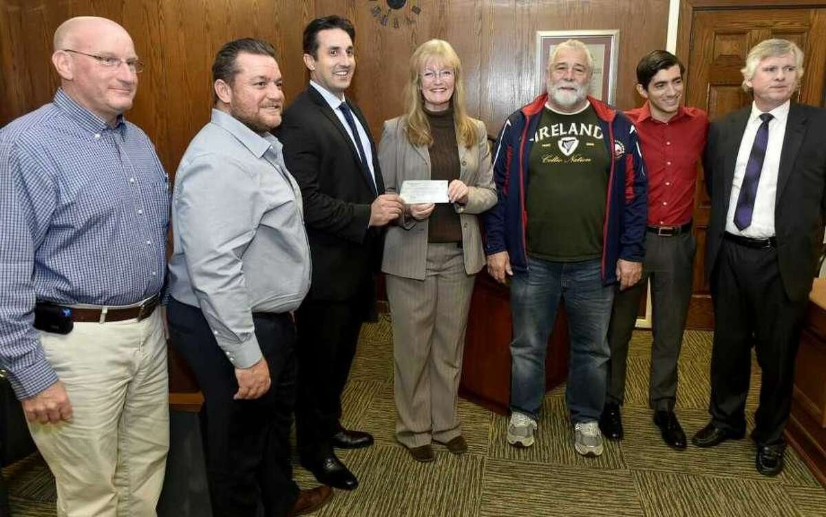 From left, city Treasurer Michael P. Last; Planning and Development Commissioner Fred A. Messore; Finance Director Ronald Cicatelli; Mayor Nancy Rossi; state Rep. Charles J. Ferraro ; state Rep. Michael DiMassa; and Corporation Council Lee Tiernan at West Haven City Hall Friday.